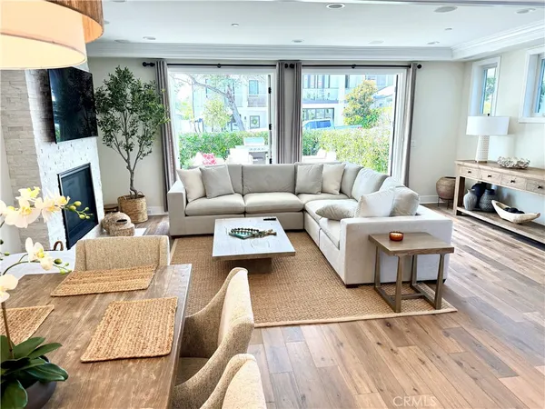 a living room with furniture a large window and a flat screen tv