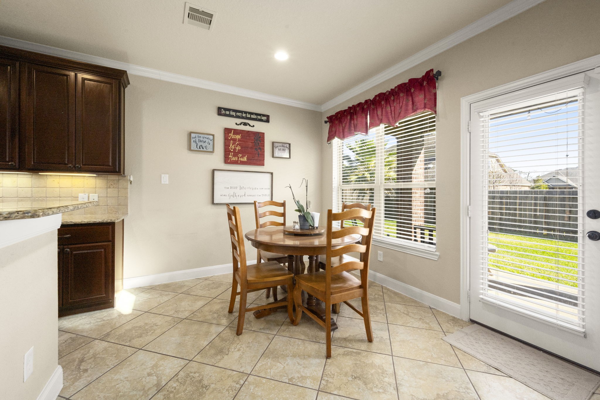25306 Doyle Sands Court Spring, TX 77389 - Photo 14 of 35 Bright in-kitchen dining area with backyard views, large windows, and a welcoming layout for everyday meals.