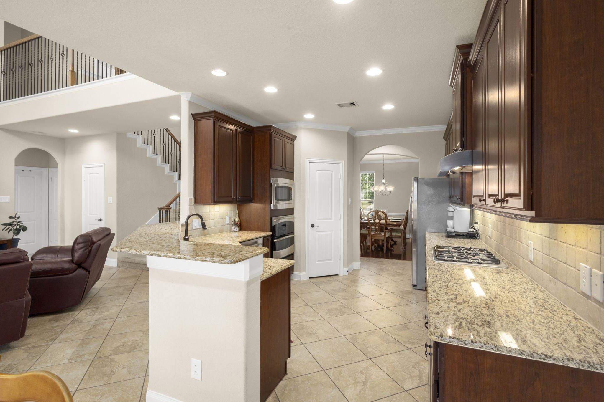 25306 Doyle Sands Court Spring, TX 77389 - Photo 16 of 35 Kitchen features crown molding and architectural details, flowing easily into the living and dining areas.