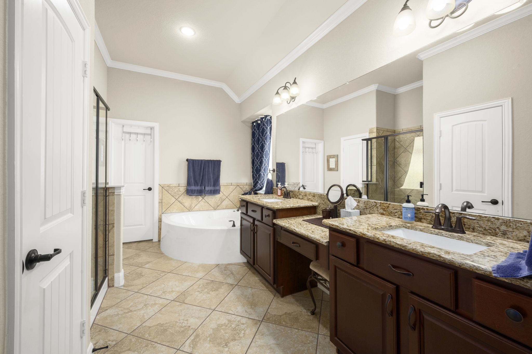 25306 Doyle Sands Court Spring, TX 77389 - Photo 19 of 35 Spa-inspired primary bathroom with a soaking tub, glass-enclosed shower, and dual vanities.