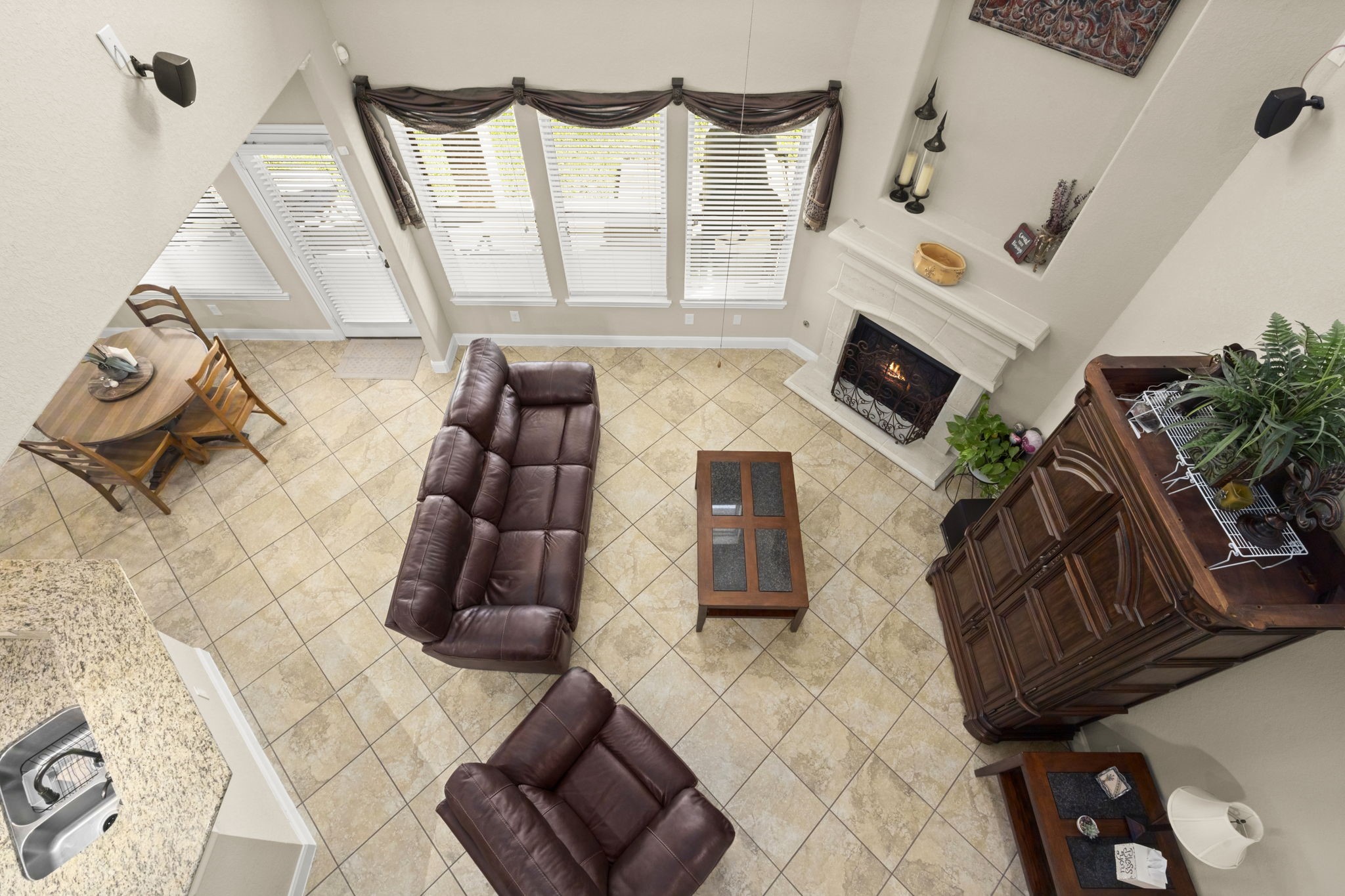 25306 Doyle Sands Court Spring, TX 77389 - Photo 25 of 35 Open living area with high ceilings, a fireplace, and seamless flow into the dining space, viewed from the second-floor catwalk.