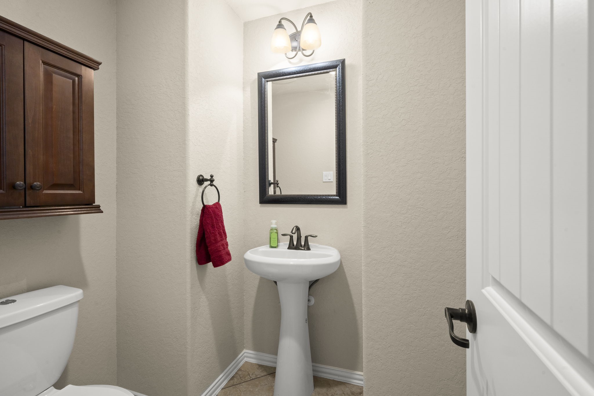 25306 Doyle Sands Court Spring, TX 77389 - Photo 28 of 35 Convenient half bath with classic finishes and a clean, functional layout located between media room and game room.
