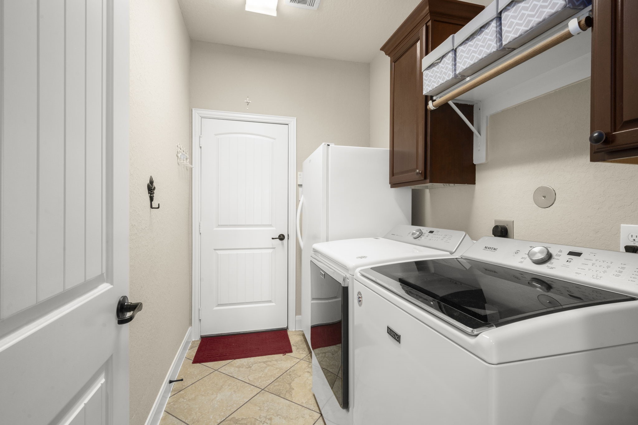 25306 Doyle Sands Court Spring, TX 77389 - Photo 33 of 35 Organized first-floor laundry room with cabinetry, modern appliances, easy-care flooring, and direct access to the two-car garage.