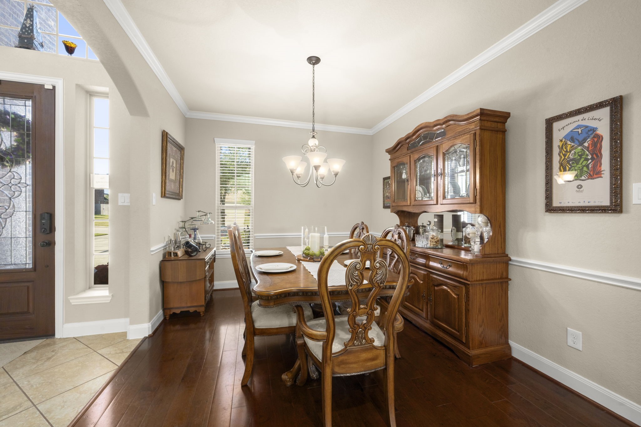 25306 Doyle Sands Court Spring, TX 77389 - Photo 9 of 35 Formal dining room with classic finishes, crown molding, and warm natural light, offering flexibility as a study, playroom, or additional living space.