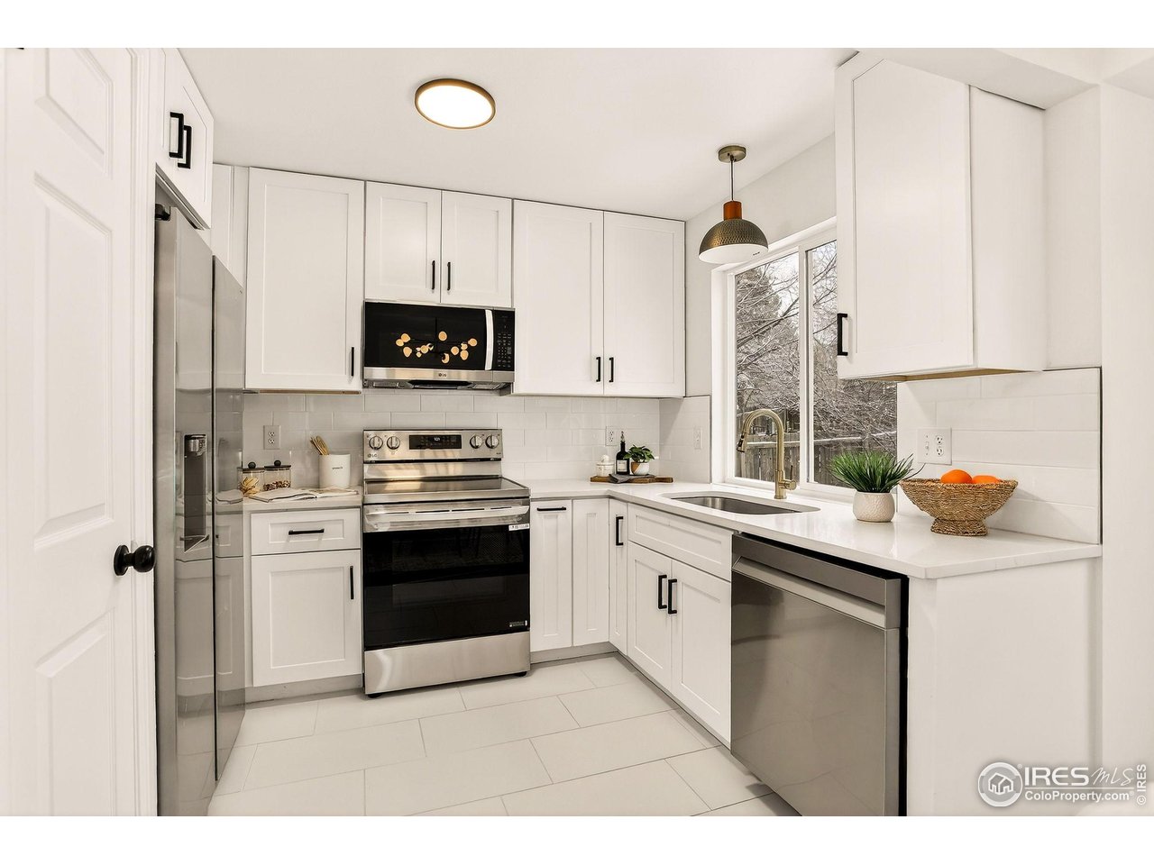 919 Vetch Circle Lafayette, CO 80026 - Photo 2 of 20 a kitchen with stainless steel appliances granite countertop a stove a sink and a refrigerator