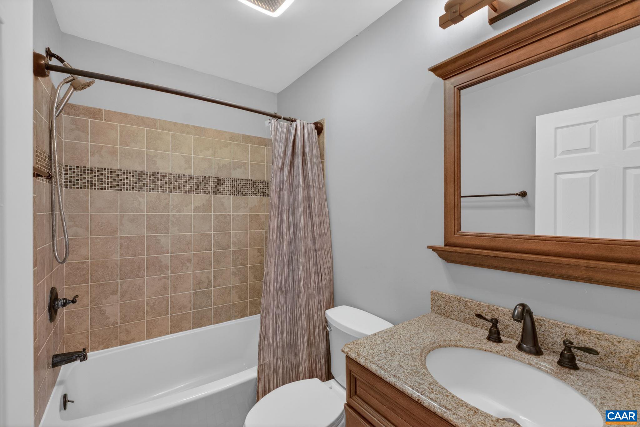 673 Cedar Lane Road Palmyra, VA 22963 - Photo 34 of 47 a bathroom with a granite countertop sink toilet a mirror and shower