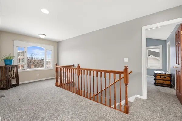 a view of hallway with furniture and windows