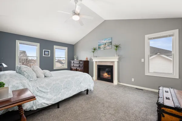 a spacious bedroom with a bed and a fireplace