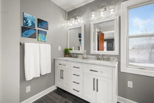 a bathroom with a double vanity sink and a mirror