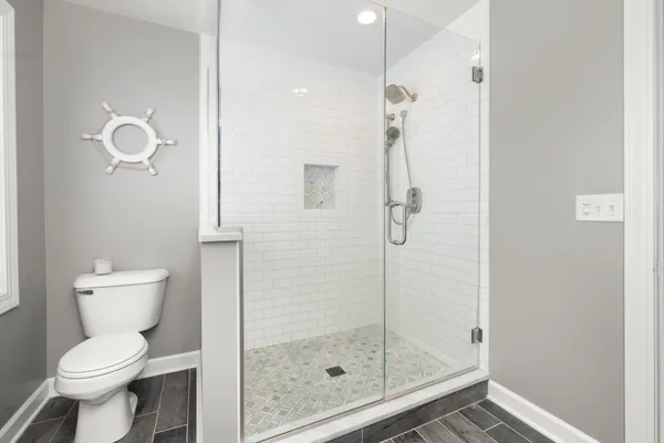a bathroom with a toilet and a shower