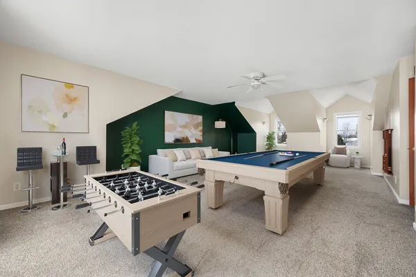 a kitchen with stainless steel appliances a stove a table and chairs