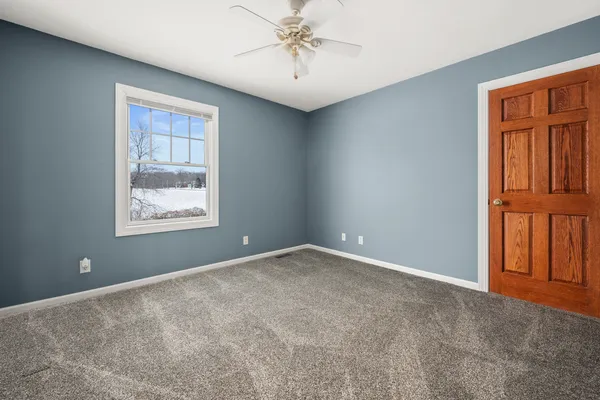 an empty room with windows and cabinet