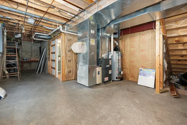 a view of a room with wooden walls and furniture