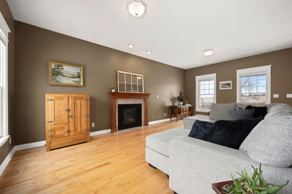 a living room with furniture a fireplace and a window
