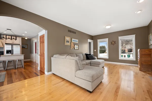 a living room with furniture and a wooden floor