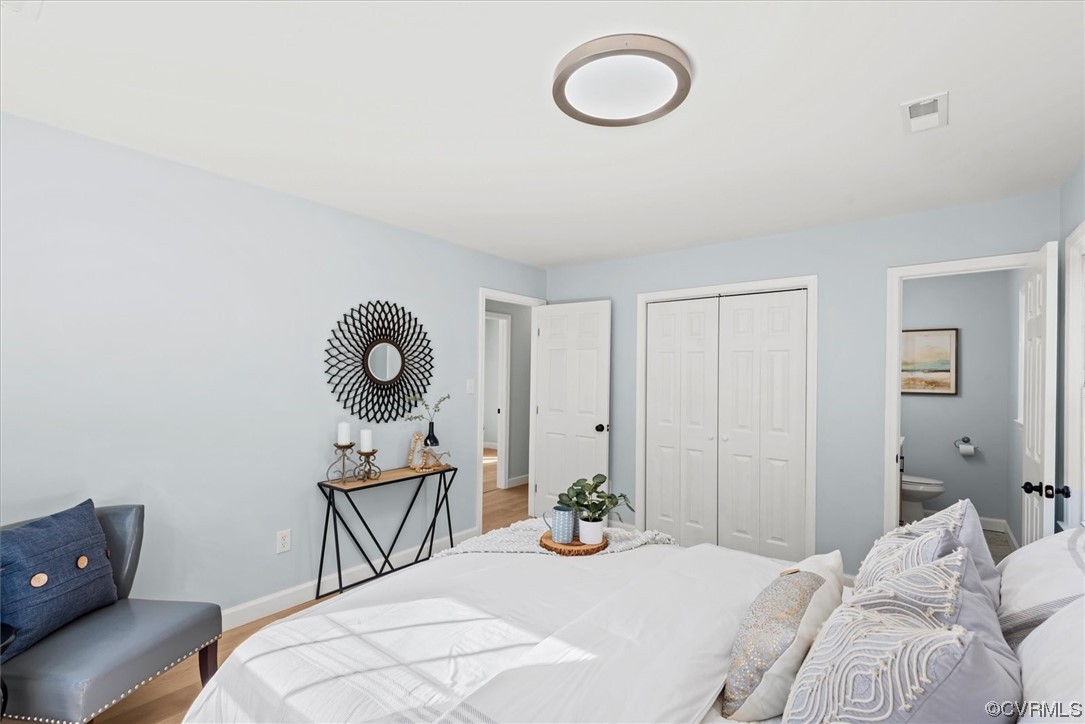 713 Goodwood Road Richmond, VA 23225 - Photo 14 of 29 a bedroom with a bed and a chandelier
