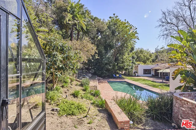 a view of a house with a yard and sitting area