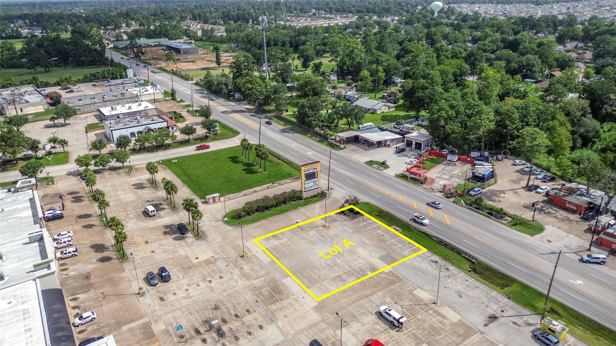 an aerial view of a tennis ground and trees in the background