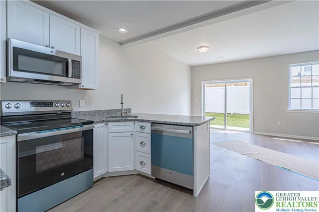 a kitchen with granite countertop a stove and a sink