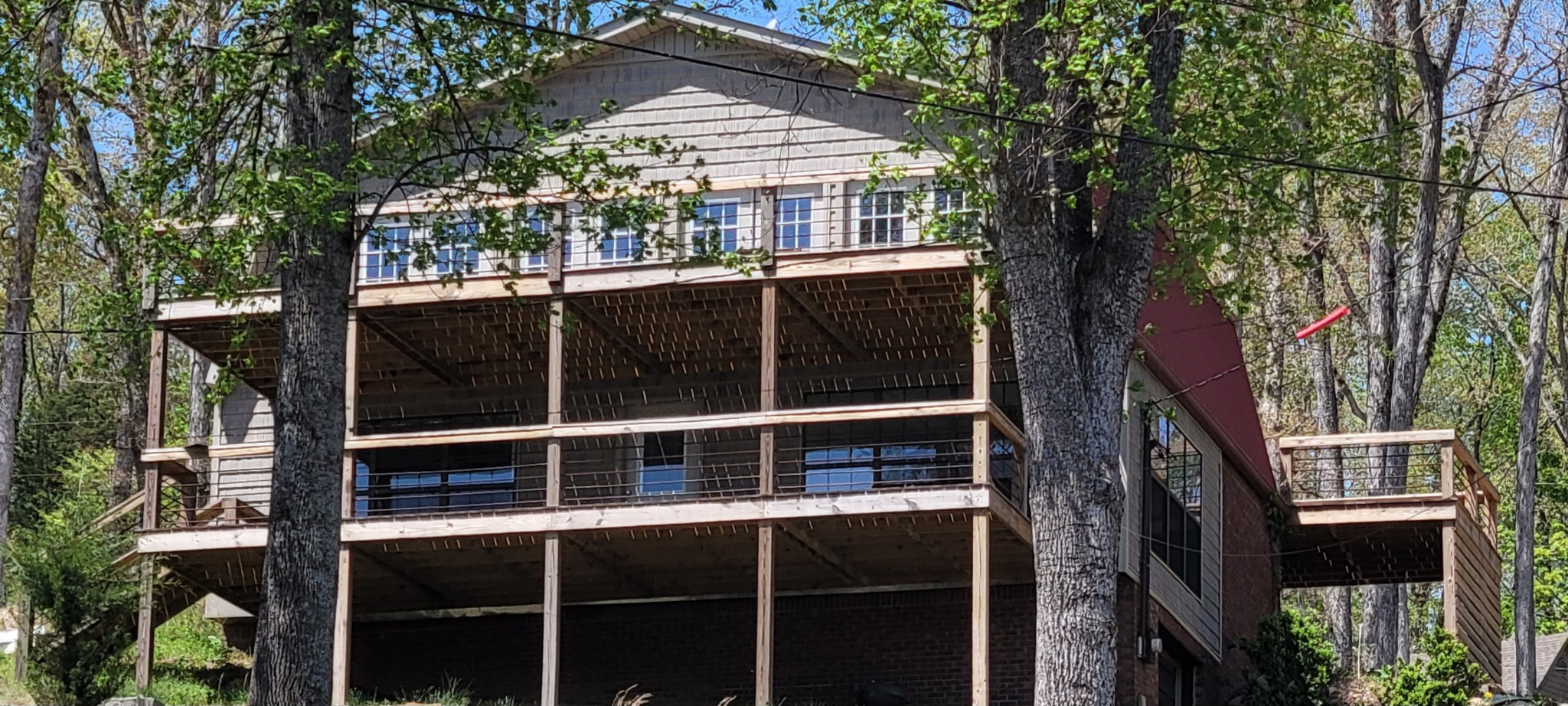 a view of a house with a large window and wooden fence