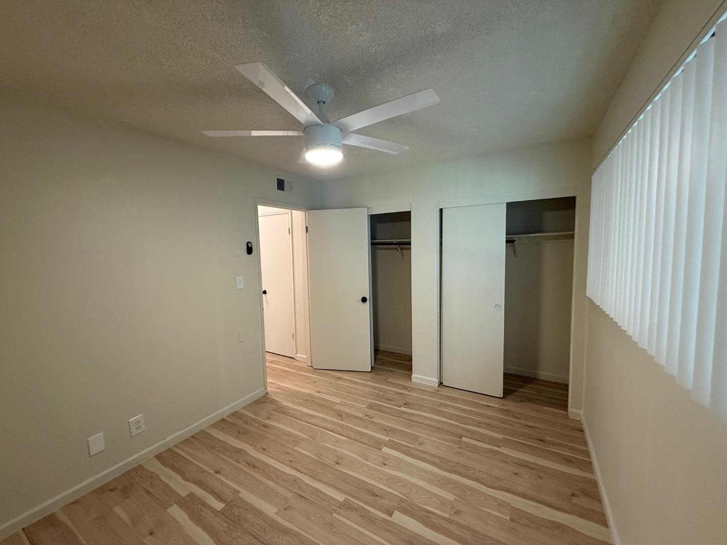2505 Prescott Road, Unit 1 Modesto, CA 95350 - Photo 34 of 42 a view of an empty room with wooden floor and a window