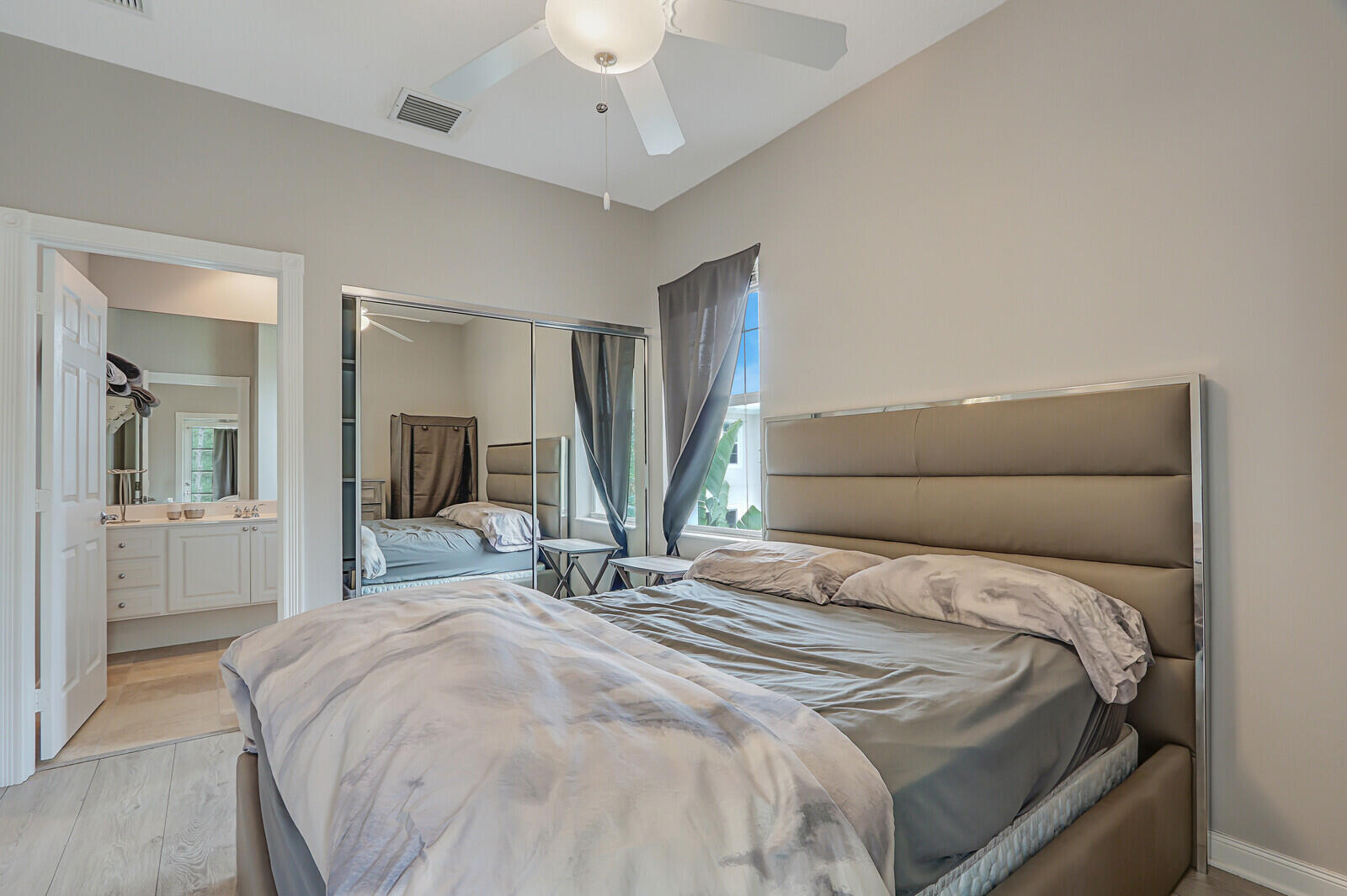 101 St Pierre Way Jupiter, FL 33458 - Photo 43 of 57 a bedroom with a large bed and a chandelier
