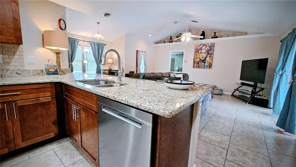 a kitchen with granite countertop a sink and a stove top oven