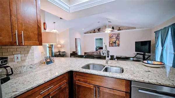 a kitchen with granite countertop a sink and a stove top oven