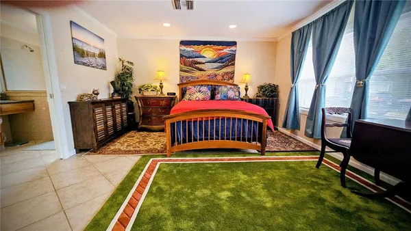 a bedroom with furniture and a flat screen tv