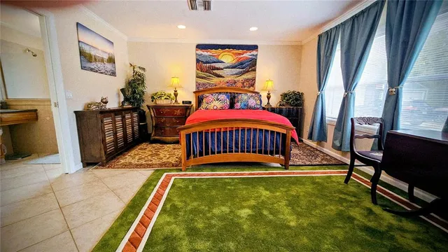 a bedroom with furniture and a flat screen tv