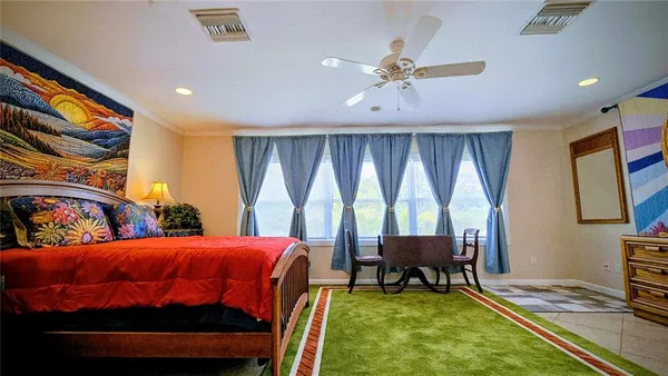 a bedroom with a bed and a chandelier