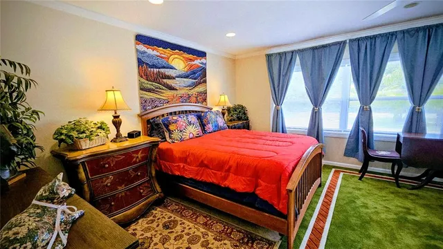 a bedroom with a bed and a bookshelf with wooden floor