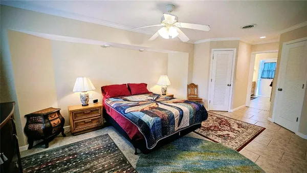 a bedroom with bed and a chandelier