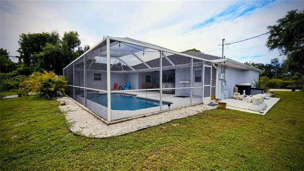 a view of a house with a yard and sitting area