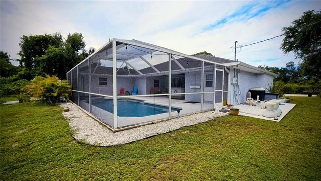 a view of a house with a yard and sitting area