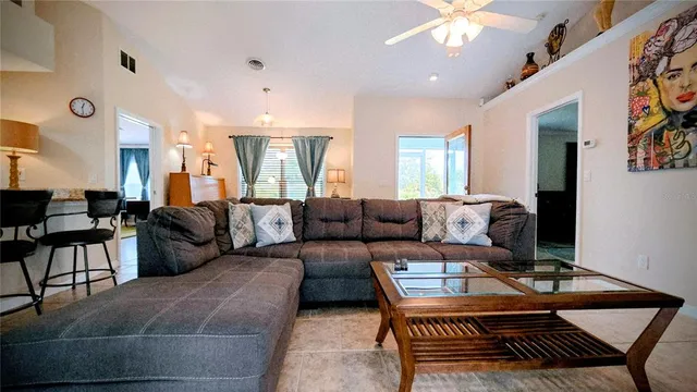 a living room with lots of furniture and a chandelier