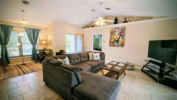 a living room with furniture and a flat screen tv