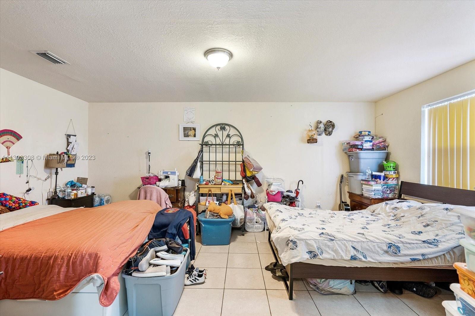 11750 Southwest 223rd Street Miami, FL 33170 - Photo 11 of 28 a bed room with bed and a windows