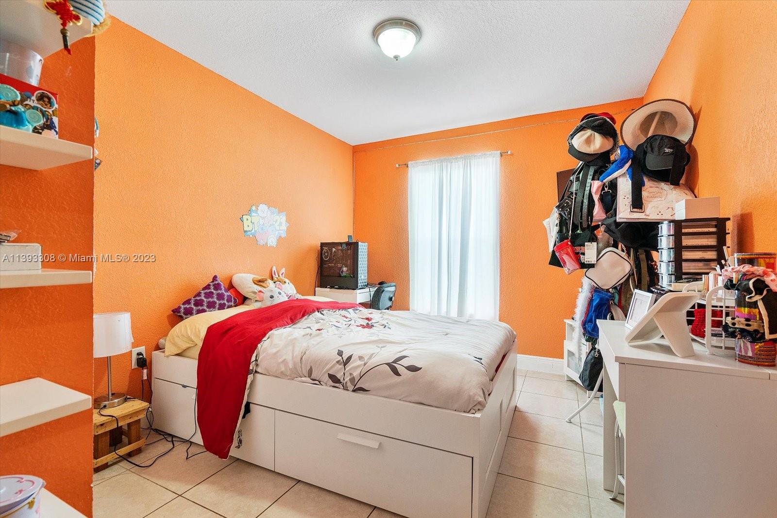 11750 Southwest 223rd Street Miami, FL 33170 - Photo 14 of 28 a bedroom with bed and a window