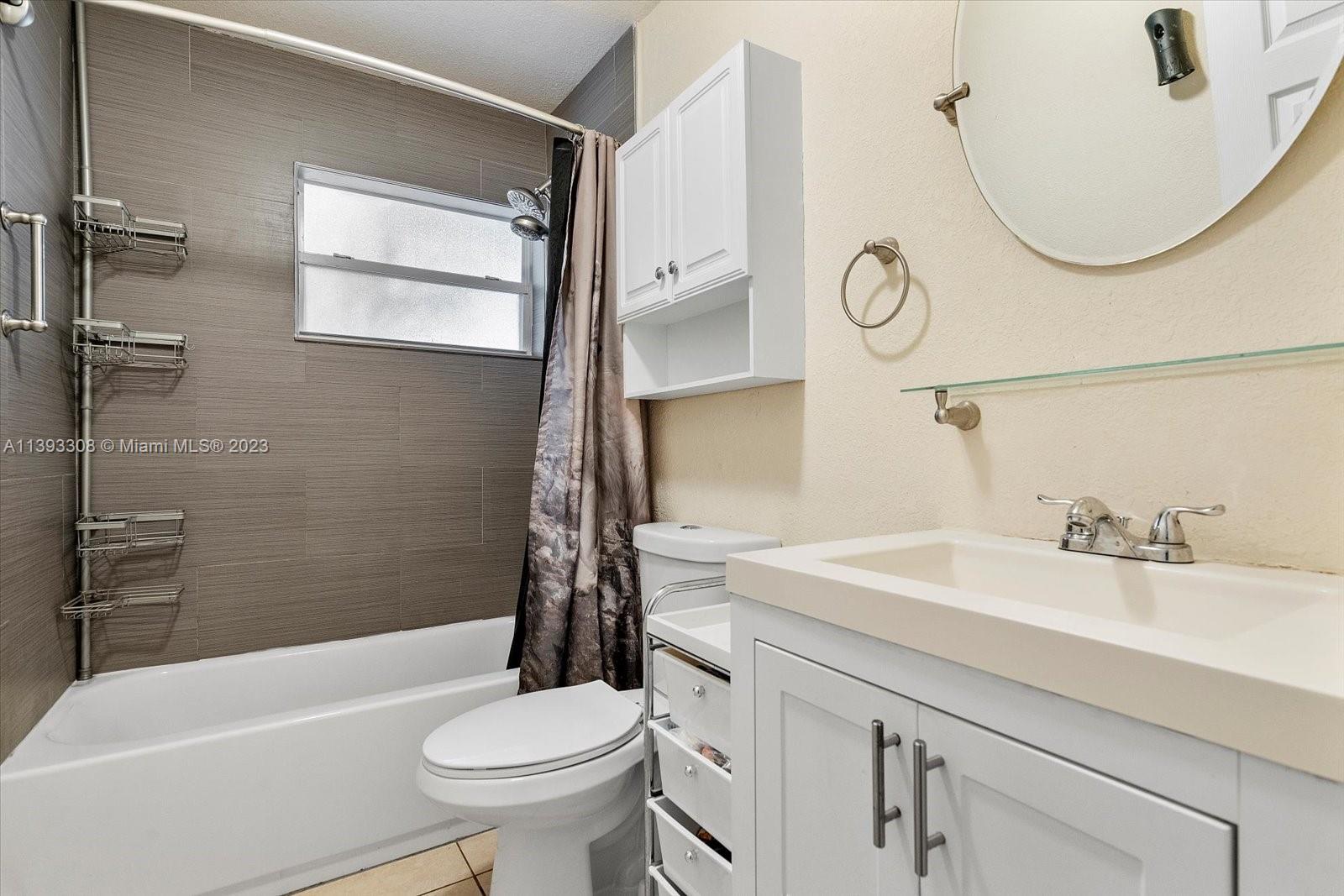 11750 Southwest 223rd Street Miami, FL 33170 - Photo 17 of 28 a bathroom with a sink a toilet and a mirror