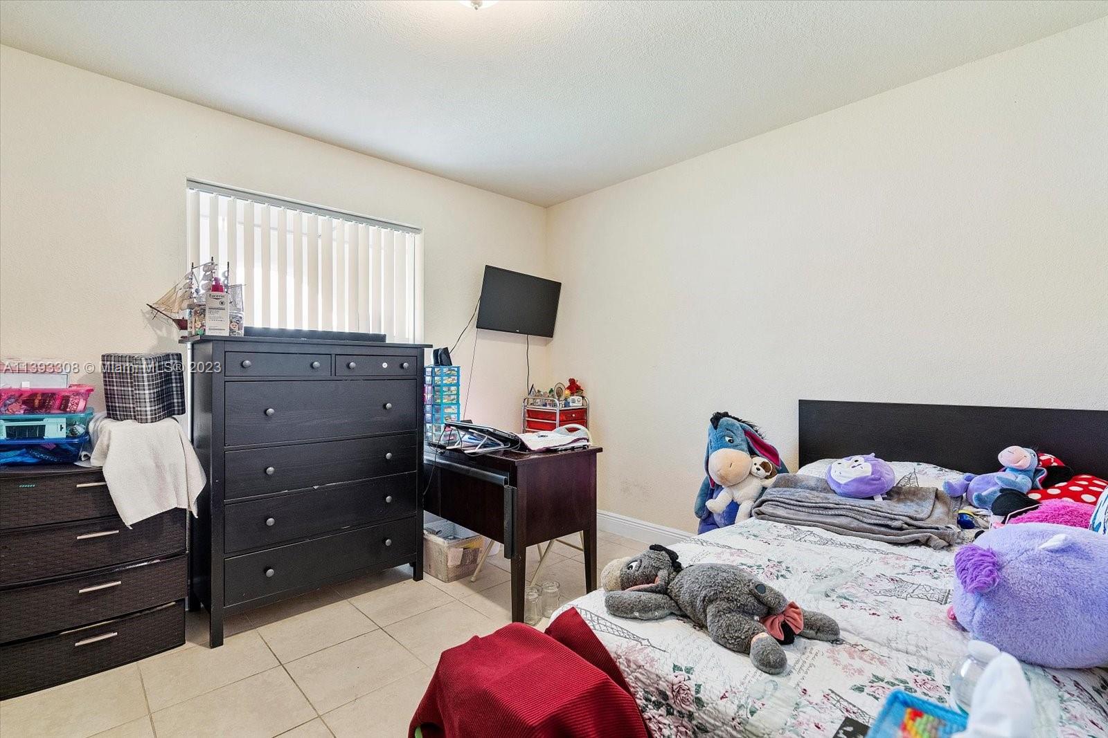 11750 Southwest 223rd Street Miami, FL 33170 - Photo 20 of 28 a bedroom with a bed and a window