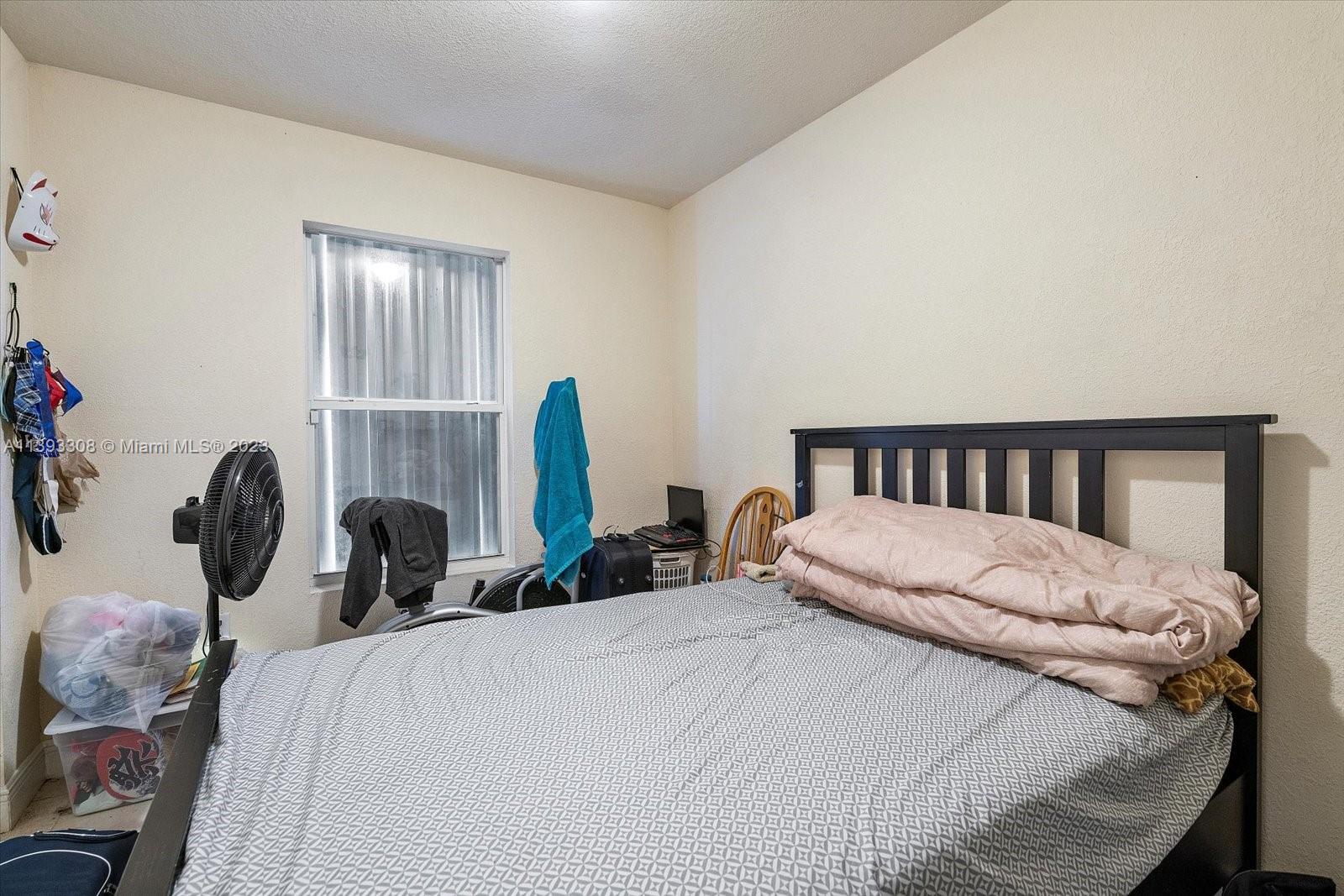 11750 Southwest 223rd Street Miami, FL 33170 - Photo 21 of 28 a bedroom with a bed and window