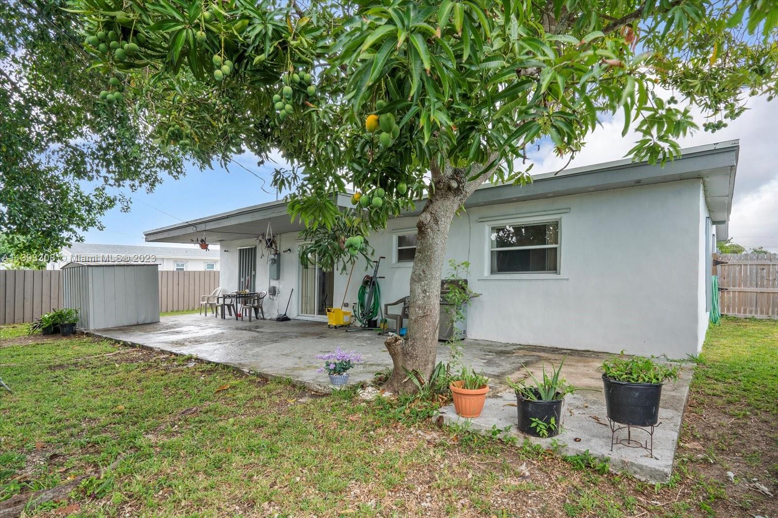 11750 Southwest 223rd Street Miami, FL 33170 - Photo 24 of 28 a backyard of a house with seating space