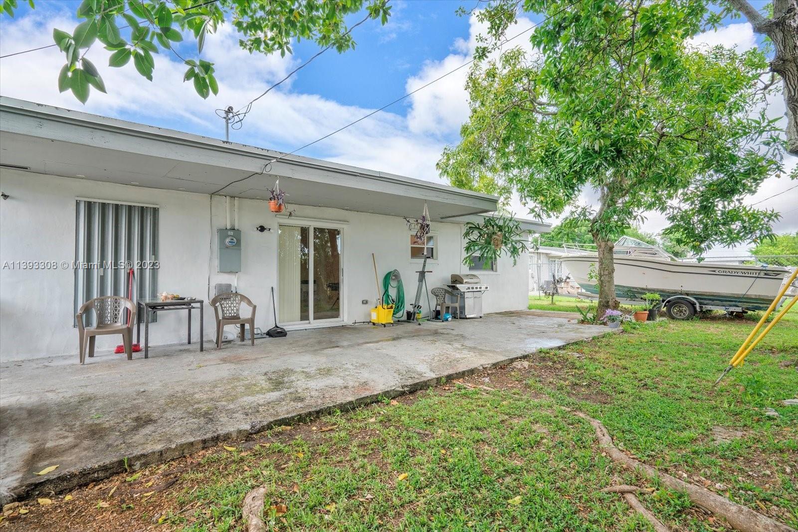 11750 Southwest 223rd Street Miami, FL 33170 - Photo 25 of 28 a front view of a house with garden