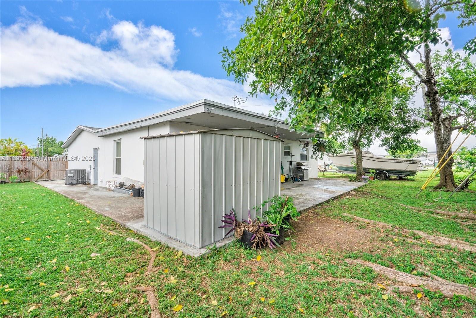 11750 Southwest 223rd Street Miami, FL 33170 - Photo 26 of 28 a front view of a house with garden