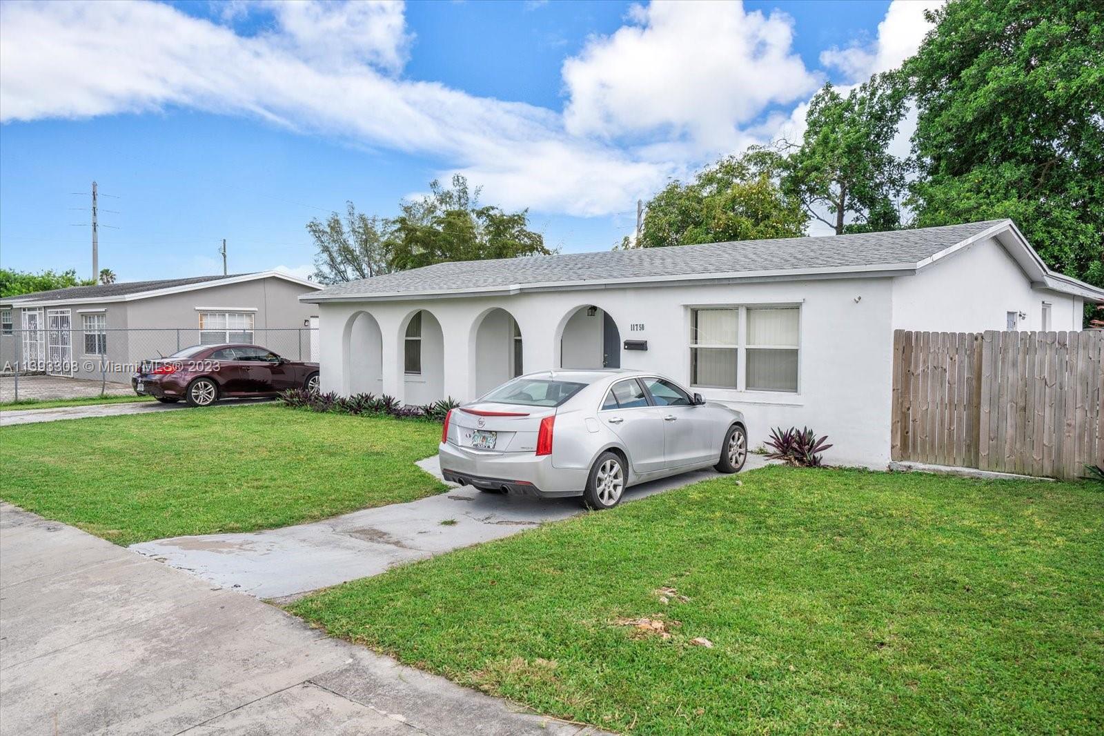 11750 Southwest 223rd Street Miami, FL 33170 - Photo 3 of 28 a white house covered with tall trees