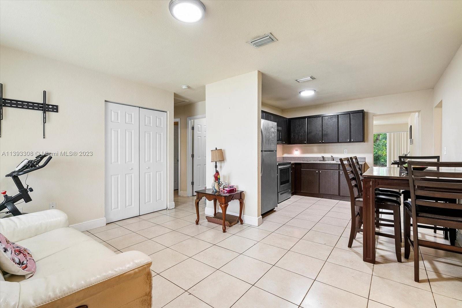 11750 Southwest 223rd Street Miami, FL 33170 - Photo 5 of 28 a living room with furniture and kitchen view
