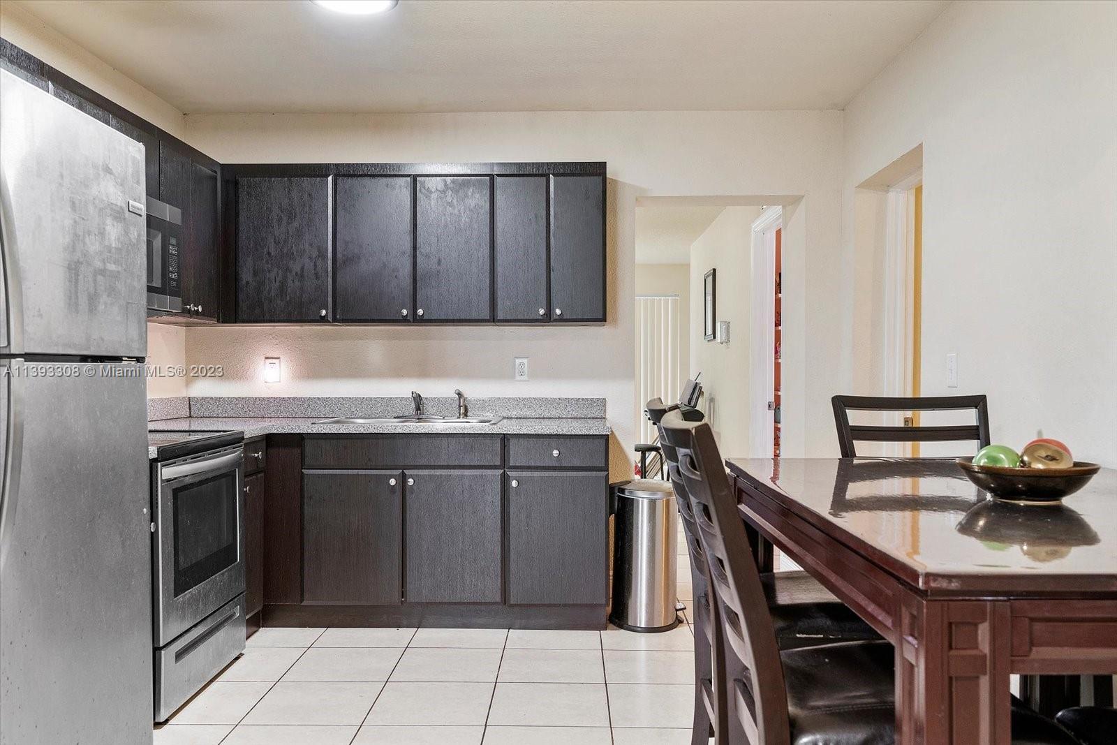 11750 Southwest 223rd Street Miami, FL 33170 - Photo 6 of 28 a kitchen with a sink stove and cabinets