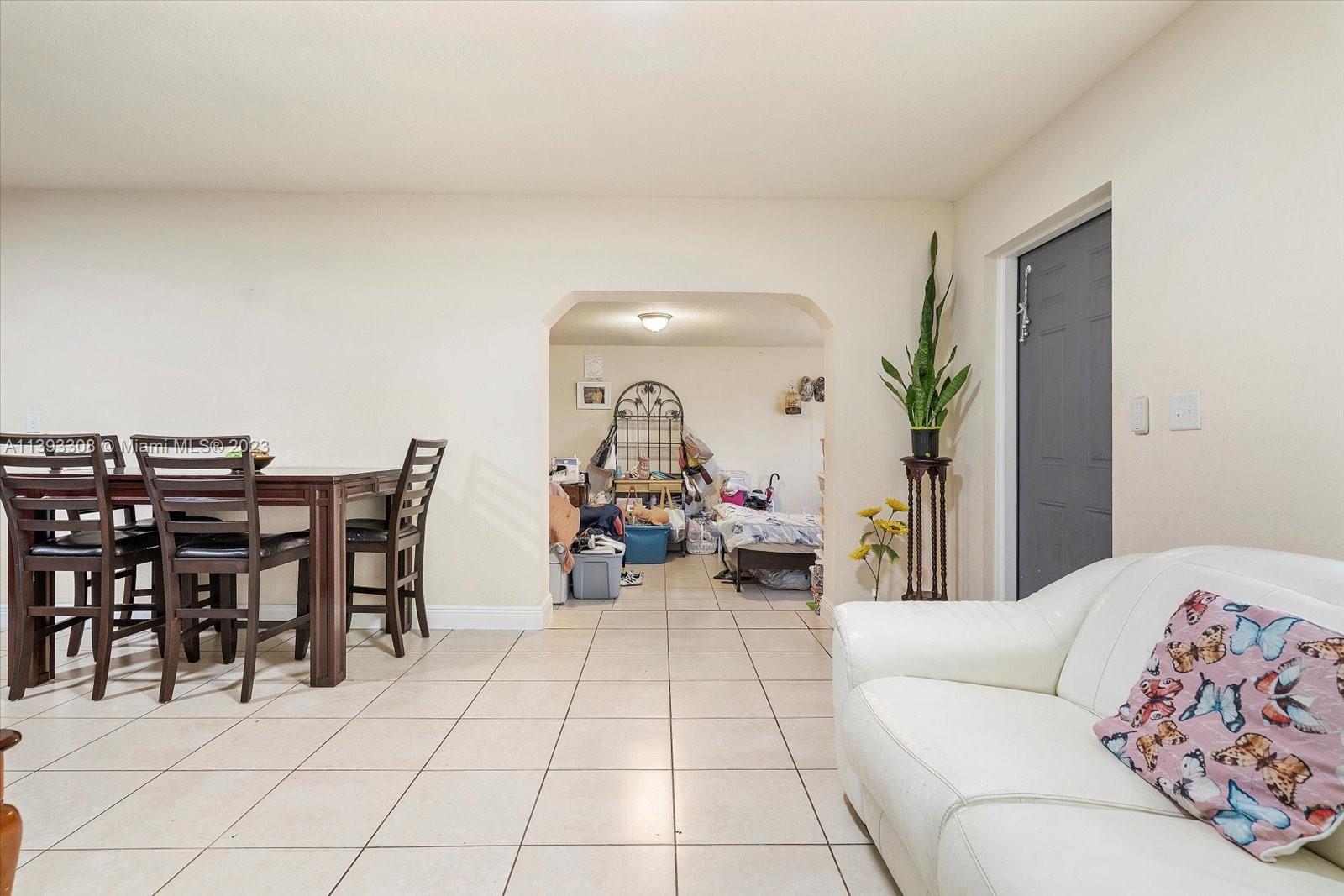 11750 Southwest 223rd Street Miami, FL 33170 - Photo 9 of 28 a living room with furniture and a potted plant