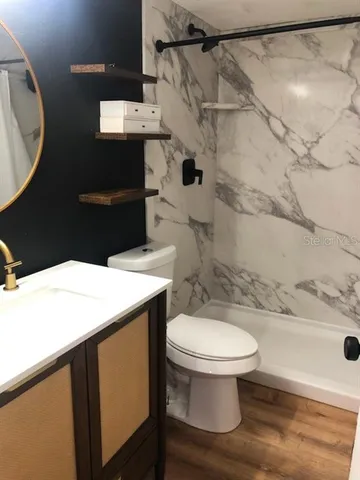 a bathroom with a sink toilet and a mirror